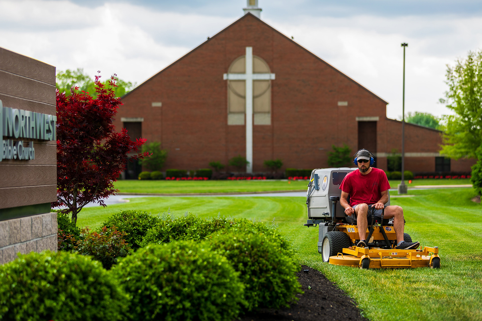 Steve Halter mowing in front of church