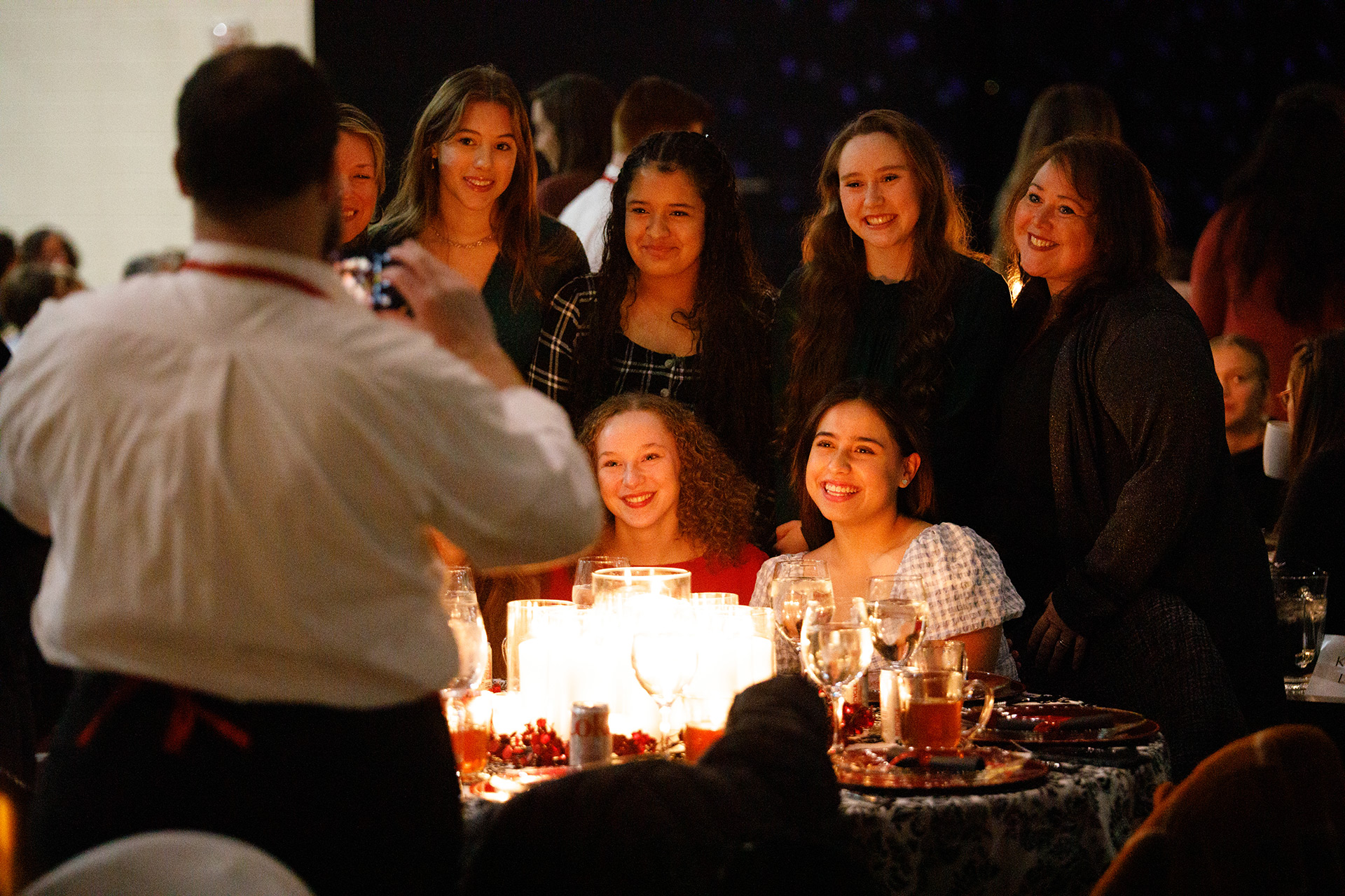 A table of young ladies poses for a picture during the Christmas Tea
