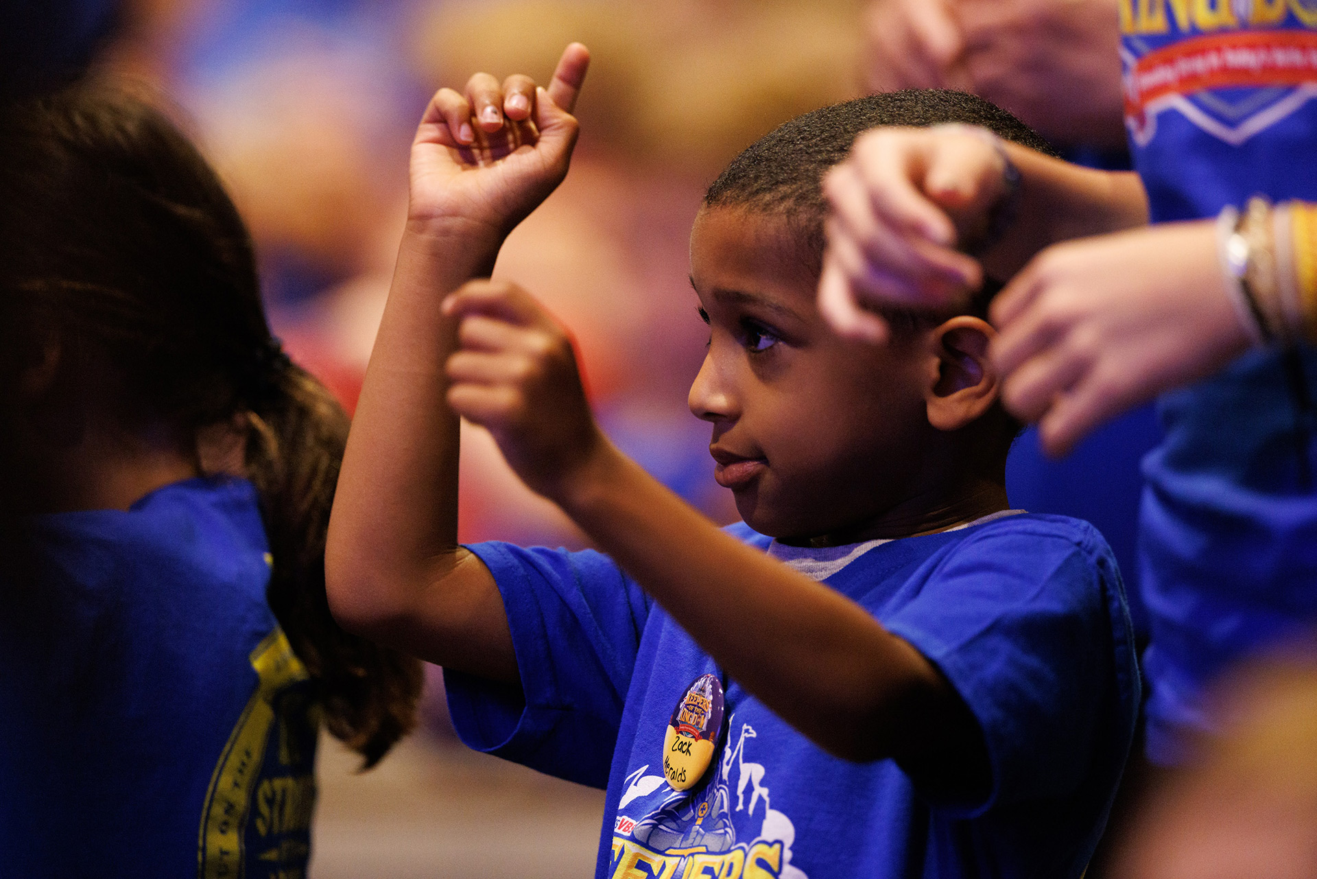 Children doing hand motions to VBS songs